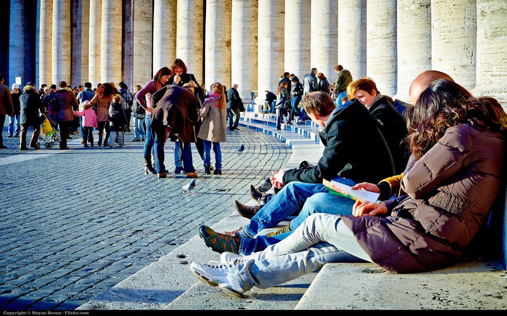 Tourists lying on the entrance of Saint Peter in Rome